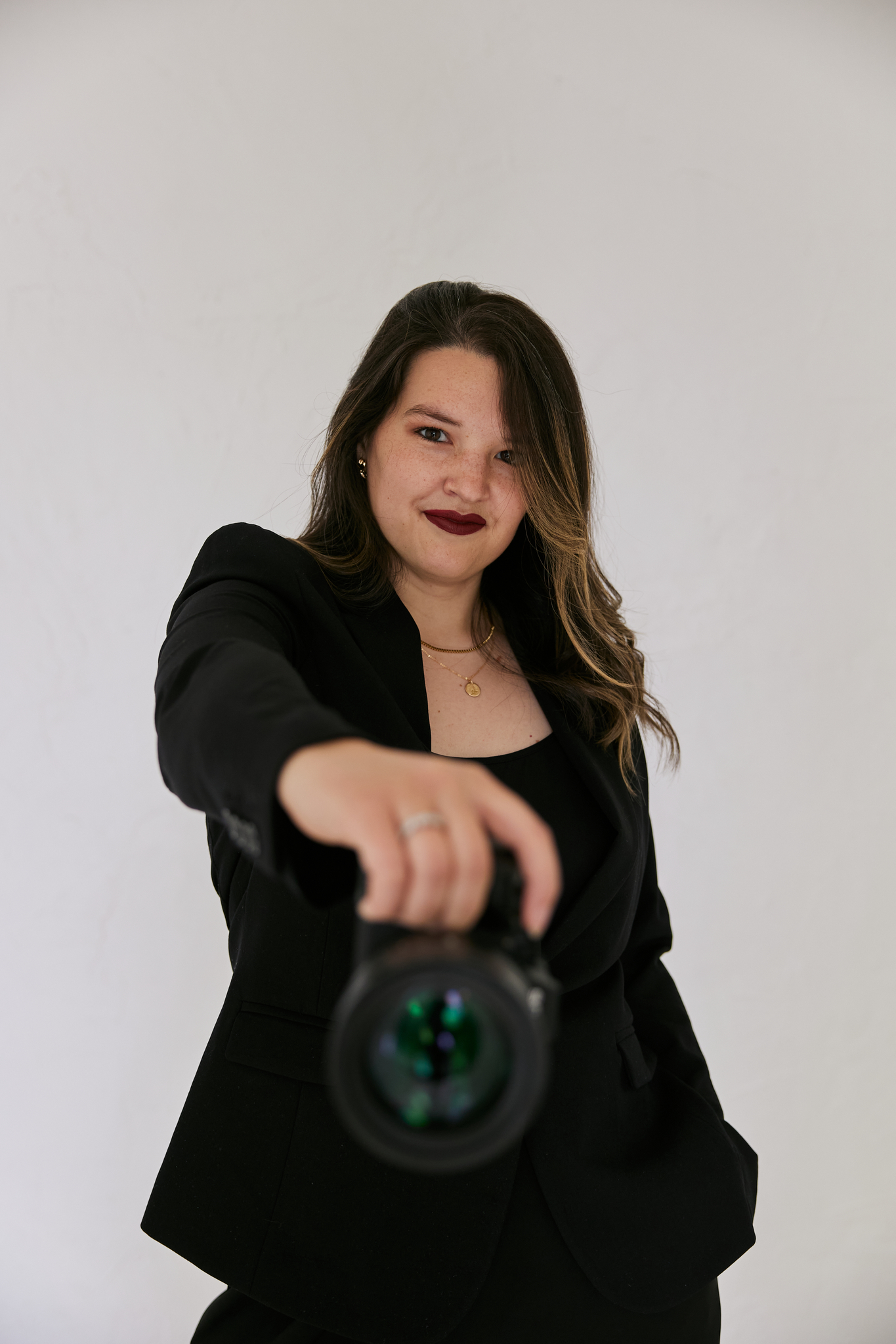 woman standing against wall in green skirt